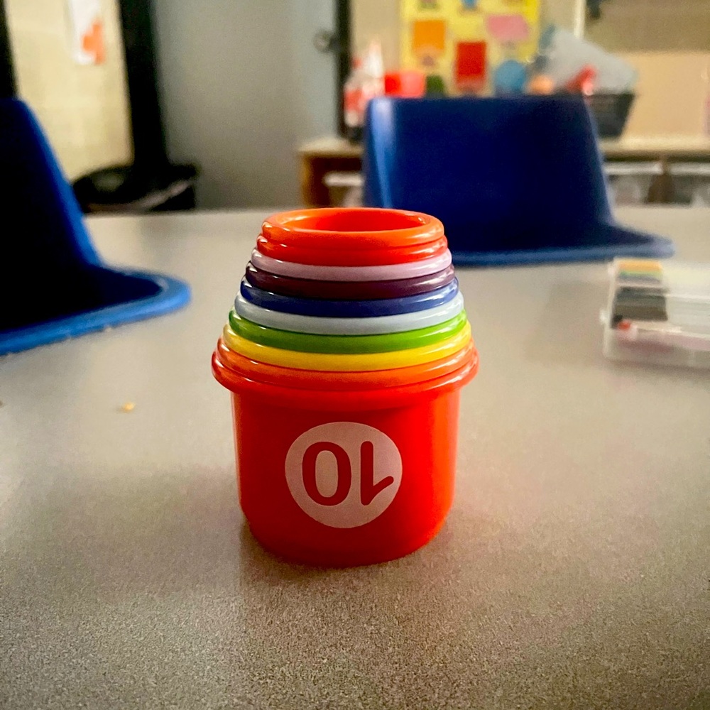 Kids learning stacking cups, numbered 1-10